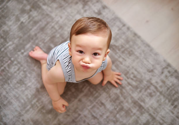istock Cute baby is looking to camera 812463534
