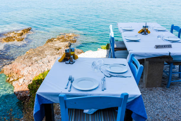 istock Empty tables of the restaurant on a cliff with an inscription reserved 812463946