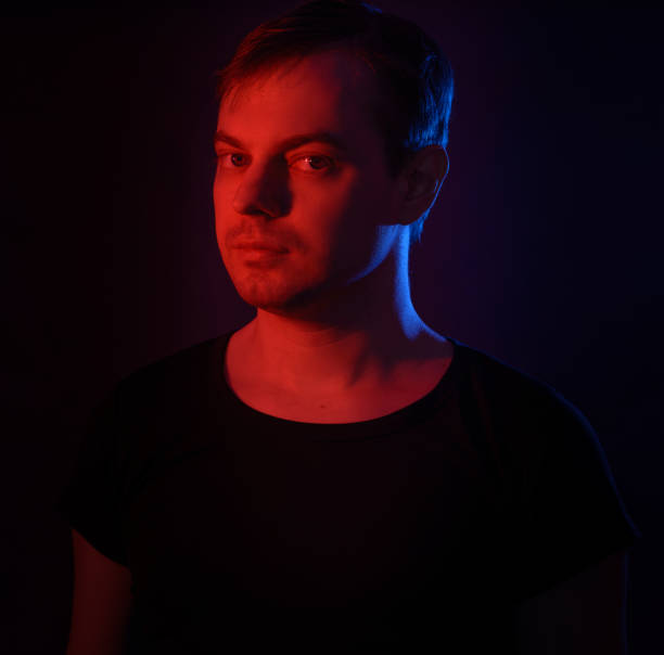 istock Portrait of a man with colored light. 812481596