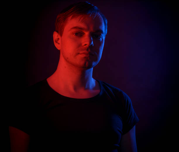 istock Portrait of a man with colored light. 812481658