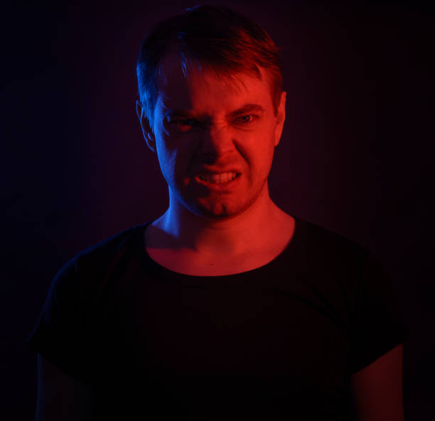 istock Portrait of a man with colored light. 812481734