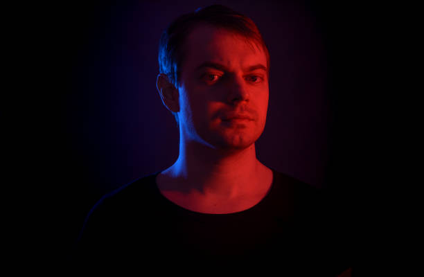 istock Portrait of a man with colored light. 812481770