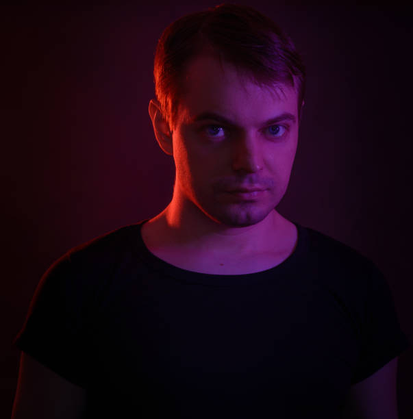 istock Portrait of a man with colored light. 812481906