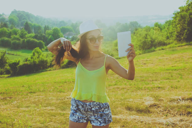 woman holding tablet in the nature,summer