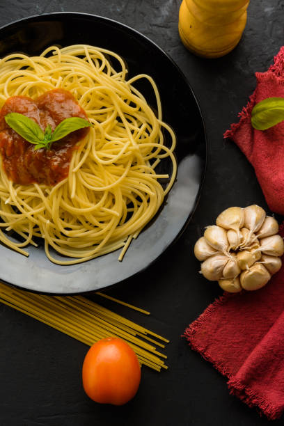 istock spaghetti with tomato sauce and their ingredients around 812494804