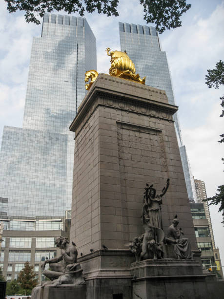 USS Maine Monument Manhattan New York City USS Maine monument designed by Harold Van Buren Magonigle (1913) at Columbus circle and the Times Warner Center modern twin towers, Manhattan, New York City. time warner center columbus circle pictures stock pictures, royalty-free photos & images