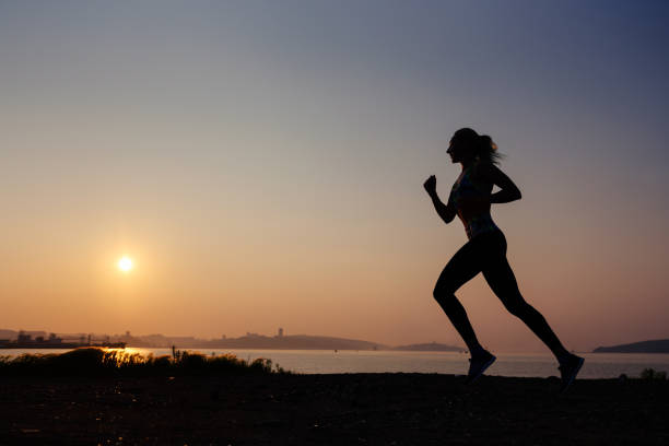 istock The woman does exercises at sunrise 812504476