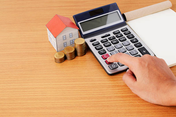 istock Calculating with Coins stack and paper house and notepad 812523858