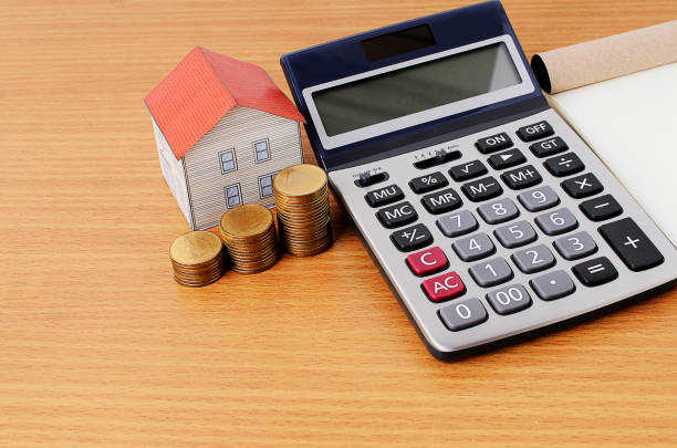 istock Mortgage loans concept with calculator and coins stack and paper house 812523870