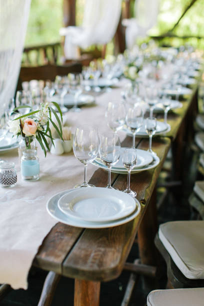 istock Glasses on the festive table setting. Wedding table decor. Table setting in classic style, setout, layout 812526436