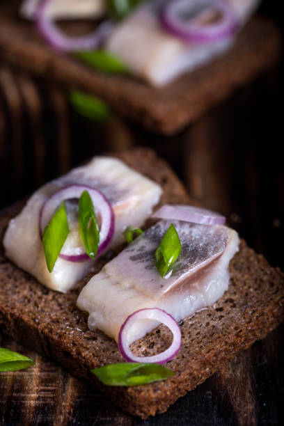 istock snack of rye bread, herring and onions 812542134