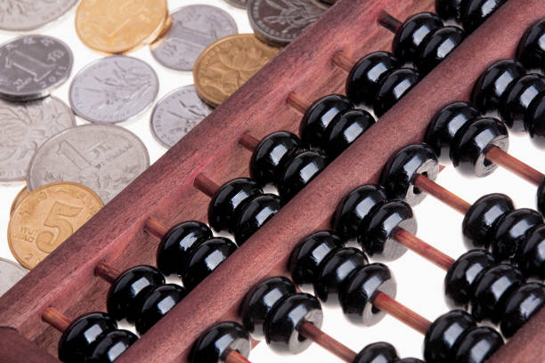 istock Old wooden Chinese Abacus and Chinese coins 812557926