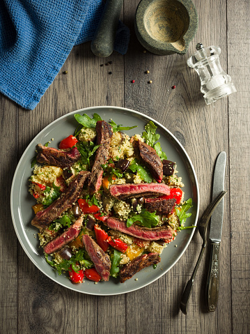 Home made freshness roasted vegetable couscous salad with char-grilled rare ribeye steak