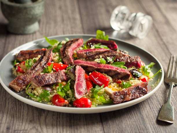 istock Roasted vegetable couscous salad with rare ribeye steak 812563996