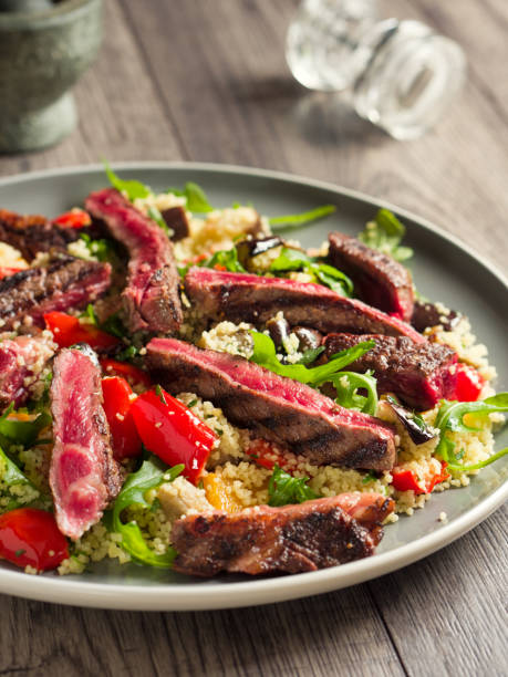 istock Roasted vegetable couscous salad with rare ribeye steak 812564006
