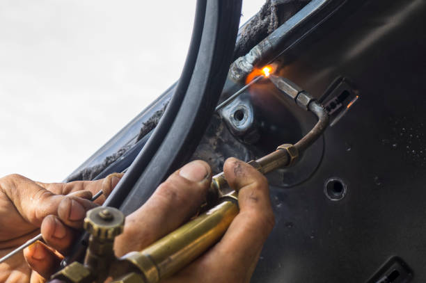 istock Close up work with welding equipment - welding car body. 812571184