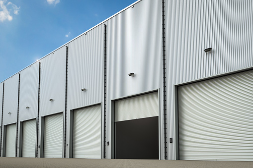 3d rendering warehouse exterior with shutter doors