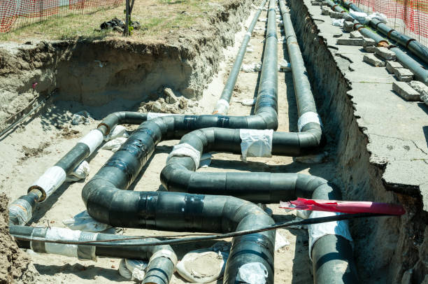 istock District heating pipeline reparation and reconstruction parallel with the street. Selective focus. 812590736