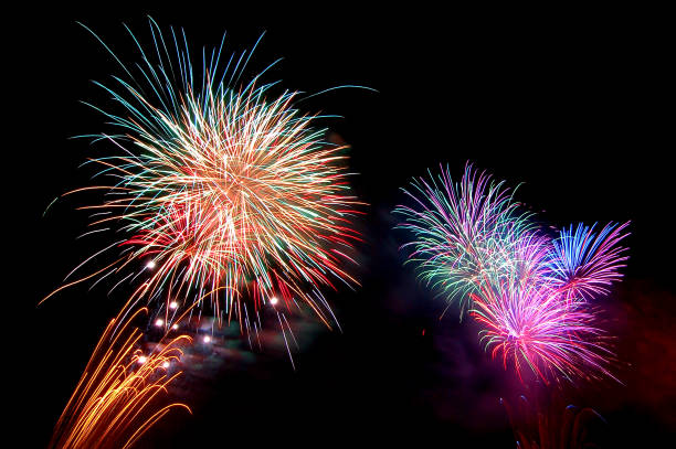 fireworks new year celebrate - beautiful colorful firework isolated display with light reflex in water display for celebration happy new year and merry christmas on black  background - year 2007 imagens e fotografias de stock