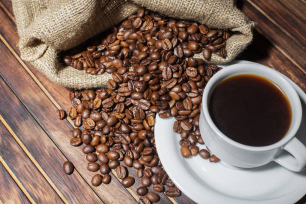 istock Cup of coffee on wooden table 812609232