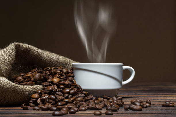 istock Traditional Coffee Cup With Shaped Steam On Rustic Wood 812609750
