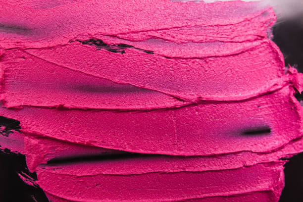istock Pink lipstick on black background strokes 812610176