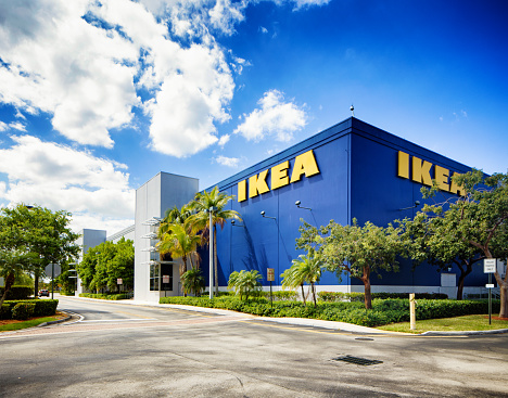 Corner view of the Ikea furniture store in Sunrise Florida near Fort Lauderdale on a mostly sunny Winter day. The image features the typical blue store with the yellow logo on its wall.