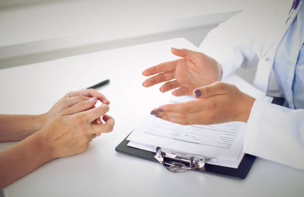 istock Doctor and patient are discussing something, just hands at the table 812640076