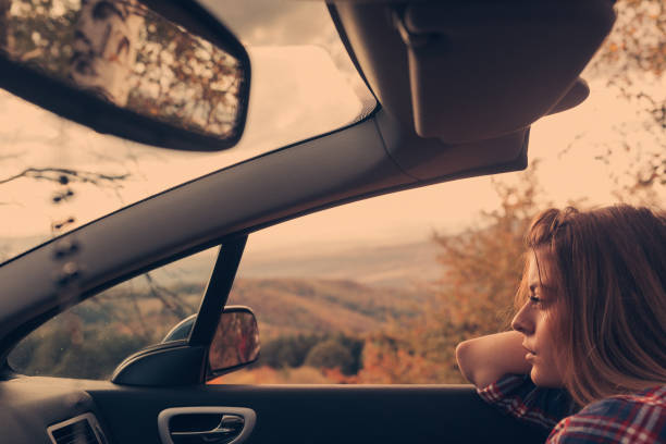 istock Thoughtful woman in cabriolet looking at view 812658006