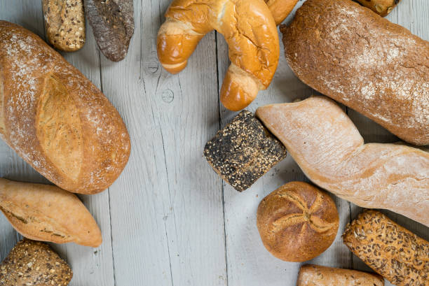 istock Assortment of baked bread on wooden table 812674612
