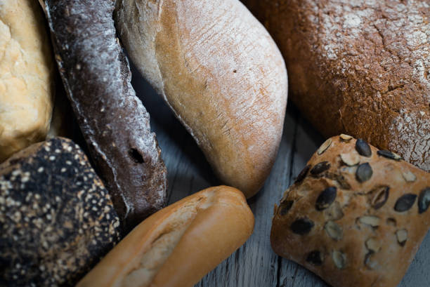 istock Assortment of baked bread on wooden table 812675048