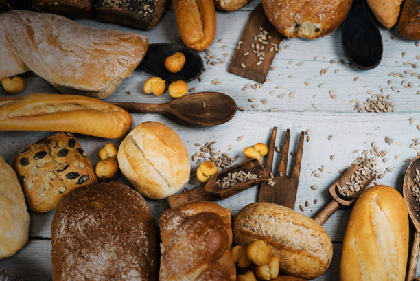 istock Assortment of baked bread on wooden table 812677230