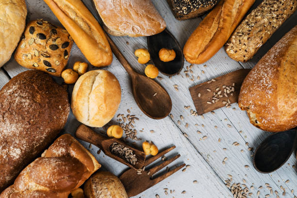 istock Assortment of baked bread on wooden table 812677232