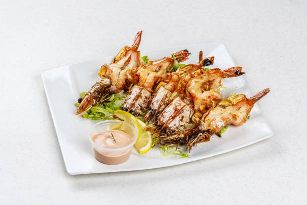 istock Grilled tiger prawns served with leafs and lemon 812677510