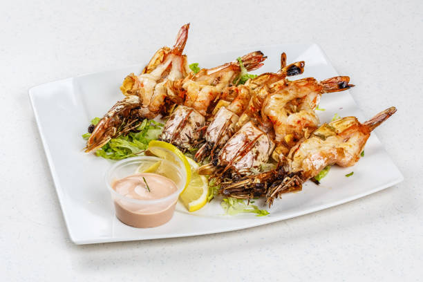 istock Grilled tiger prawns served with leafs and lemon 812677640