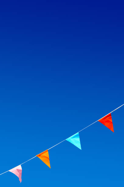 istock Colorful party flags against blue sky. 812686902