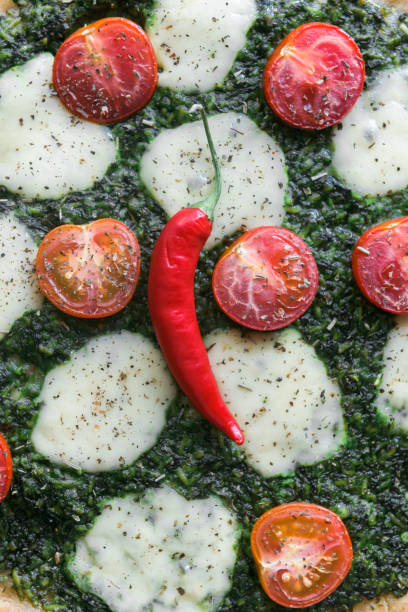 istock Appetizing pizza with pesto mozzarella and cherry and chili peppers 812687184