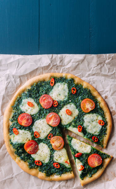 istock Appetizing pizza with pesto mozzarella and cherry and chili peppers 812687280
