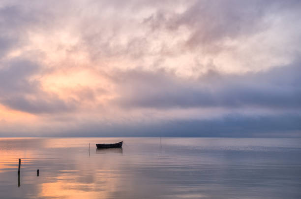 istock Old rowboat on the lake at sunset 812697292