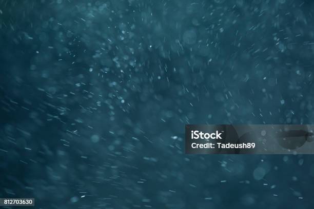 Abstract White Flakes On Blue Night Background Stock Photo - Download Image Now - Blizzard, Rain, Wind