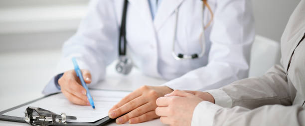 istock Doctor and  patient  sitting at the desk 812703856