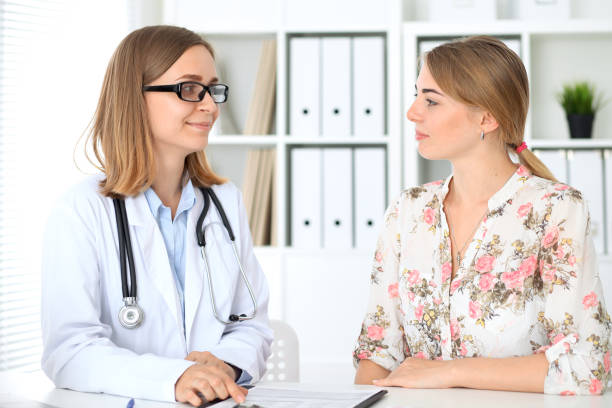istock Doctor and  patient  sitting at the desk 812706722