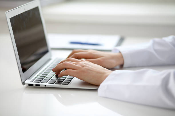 istock Female doctor typing on laptop, close up 812721602
