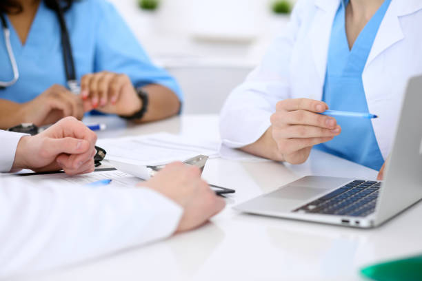 istock Group of doctors discuss at meeting 812722746