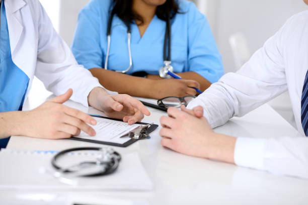 istock Two doctors and male patient discussing medical history 812728078