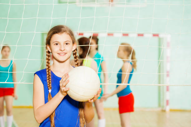 ragazza adolescente con palla da pallavolo nel padiglione sportivo - sport volleyball high school student teenager foto e immagini stock