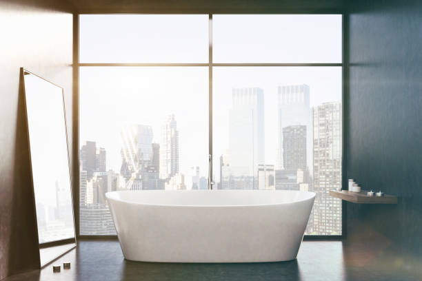istock White tub, black room, window, close up toned 812738648