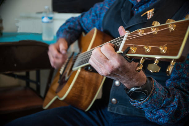 istock Western cowboy playing guitar strumming 812738806