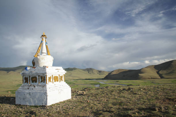 White ovoo in the Mongolian steppe with a river in the background.