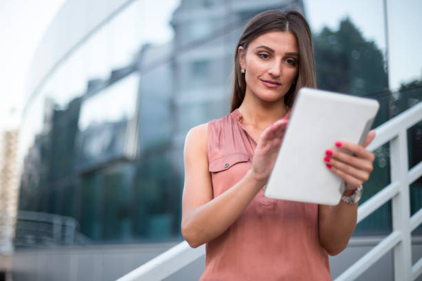 istock Businesswoman using digital tablet on the street 812738880